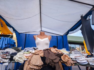 Kyiv, Ukrayna - 20 Temmuz 2025: Ukrayna 'daki bit pazarında satılık çeşitli giysileri gösteren beyaz fanila giyen manken günlük hayata ve ticarete şöyle bir göz attı