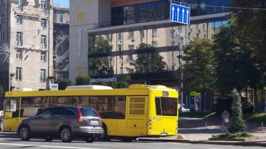 Kyiv, Ukraine - 10th July, 2025: Crowds of people walking through Kontraktova Square in Kyiv, Ukraine, with the large white ferris wheel and historical buildings creating a vibrant urban background during a sunny day