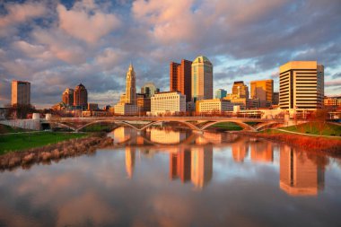 Columbus, Ohio, USA. Cityscape image of Columbus , Ohio, USA downtown skyline with the reflection of the city in the Scioto River at spring sunset. clipart