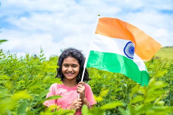 stock image Happy smiling teenager girl holding indian flag at farmland - concept of freedom, patriotism and education.