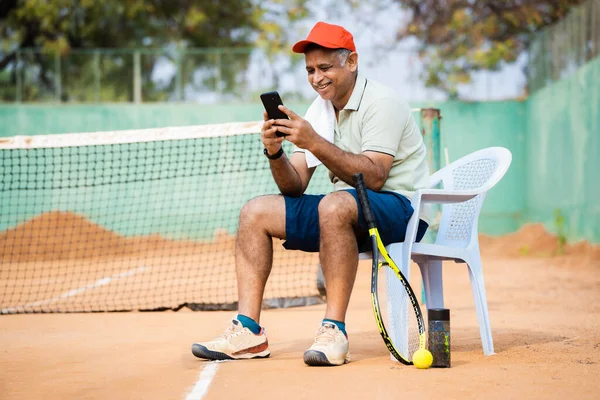 Щасливий Старший Чоловік Тенісному Корті Зайнятий Використанням Мобільного Телефону Під — стокове фото