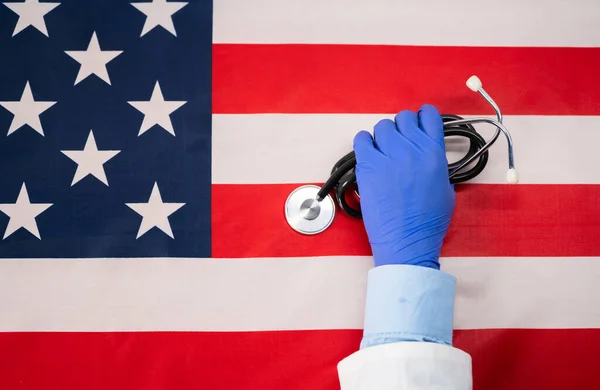 Close Tiro Mãos Médico Colocando Estetoscópio Bandeira Dos Estados Unidos — Fotografia de Stock