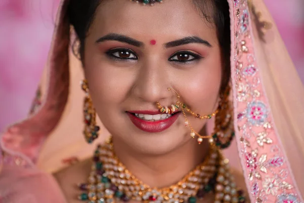 Headshot of happy smiling Indian bridal girl looking at camera during wedding - concept of Wedding Happiness, Bridal Beauty and Marriage Joyful Moment