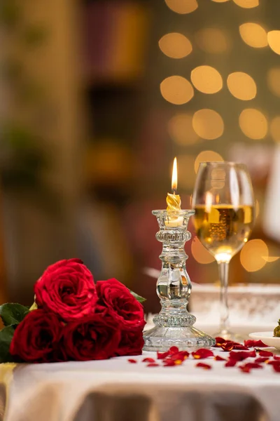 Vertical shot of valentines day dining table arrangements for couple at restaurant with flowers - concept of wedding anniversary, romantic evening and preparation.