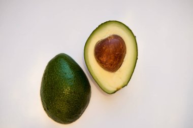 Avokado beyaz arka planda izole edildi. Avokado yarıları. Metin için boş boşluk