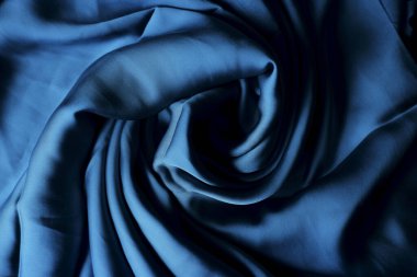 Mavi ipek kumaş. İpek kumaş dokusu. ipek arka plan. İpeksi parlak kumaş.