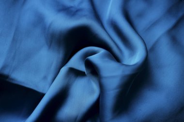 Mavi ipek kumaş. İpek kumaş dokusu. ipek arka plan. İpeksi parlak kumaş.