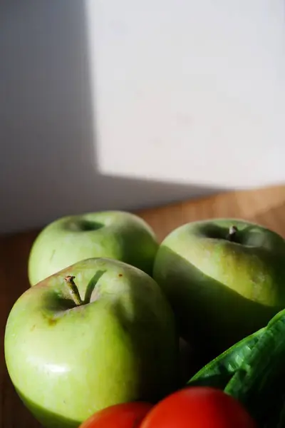 green juicy firm apples closeup on a wooden board