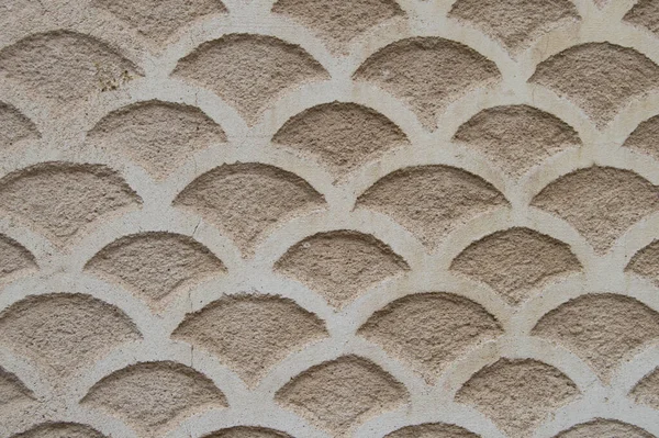 facade of a building decorated with ornamental reliefs forming waves, typical of Segovian houses. Spain