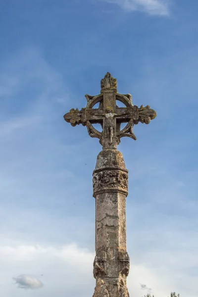 stone cross on background sky in Covarrubias, province of Burgos. Spain