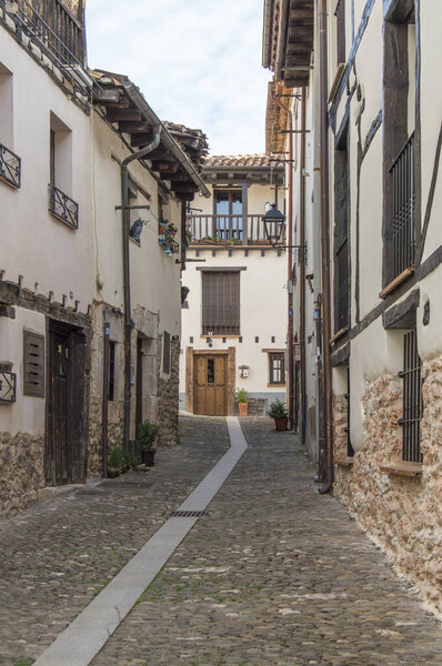 Rural street with old houses in Covarrubias, Burgos province. Spain