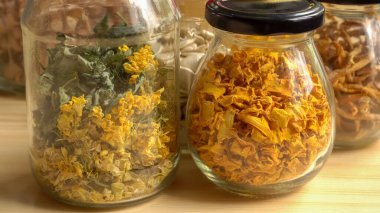 An assortment of dried herbs, flowers, and vegetables carefully stored in glass jars. These homemade ingredients are perfect for herbal teas, showcasing vibrant colors and textures. clipart