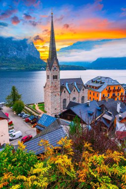 Hallstatt, Austria, Salzkammergut region: Misty autumn morning view of Hallstatter See or Lake Hallstatt and old town church in famous alpine village clipart