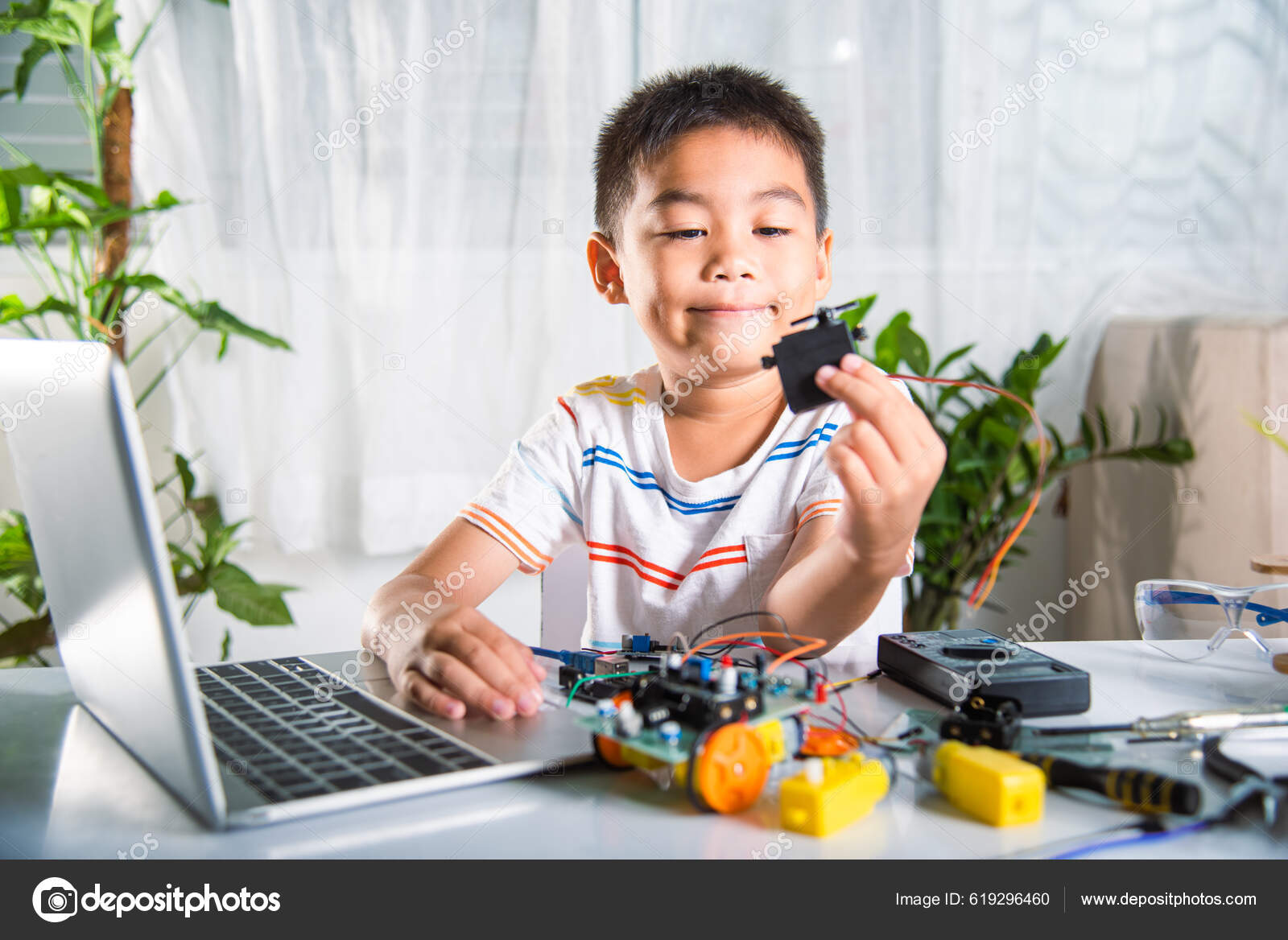 Little Boy Playing Car Game On Computer At Home Stock Photo