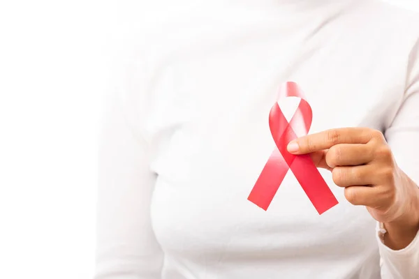 Female holding HIV AIDS awareness red ribbon on hands in studio shot isolated on over white background, Healthcare and medicine, World aids day concept