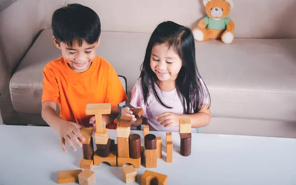 Happy Little Kids Play Wood Block Stacking Board Game Home — стоковое фото