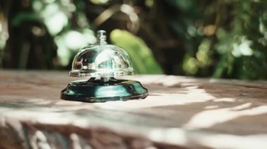 Misafirperver otel. Kahve dükkanındaki müşteri el zili, menüyü almak için çalışanları aradığı için kadın parmağı zile dokunduğu için.