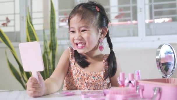 Azjatycki Uroczy Zabawny Dziewczynka Makijaż Jej Twarz Patrząc Siebie Lustrze — Wideo stockowe