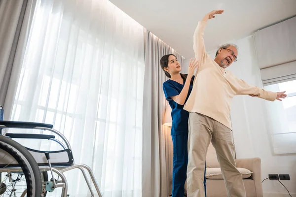 Old Senior Man Enjoys Training Physiotherapist Outstretched Arms Home Asian — ストック写真