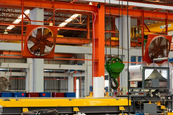 Big industrial cooler red fans in factory for reduced heat in operation ventilation of plant, industry cooling mechanical fan
