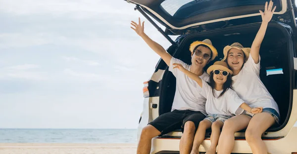 家族の日だ お父さん お母さん 娘さんが家族の後ろの車に座ってロードトリップを楽しんで手を挙げて ビーチで夏休みを楽しんでいる幸せな人々 海のビーチで休日に旅行している家族 — ストック写真