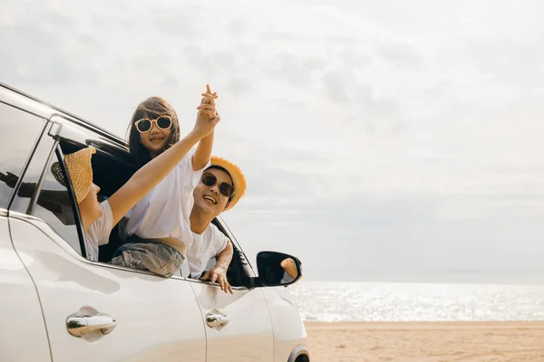 Father, mother and child smiling having fun sitting in compact white car windows raise hand wave bye bye, Summer at beach, Car insurance, Family holiday vacation travel, car travel, Happy family day
