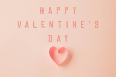 Top view flat lay pink ribbon heart shaped decorative symbol on pastel pink background, love romance concept, banner design with copy space, Mother, Woman day, Happy Valentines Day