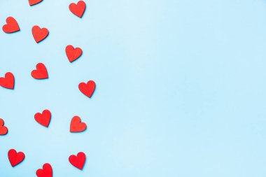 Valentines day background. red hearts composition greeting card for love Valentines day concept isolated on blue background with copy space. Top View flat lay from above