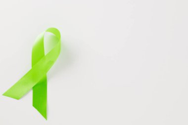 Green awareness ribbon of Gallbladder and Bile Duct Cancer month isolated on white background with copy space, concept of medical and health care support