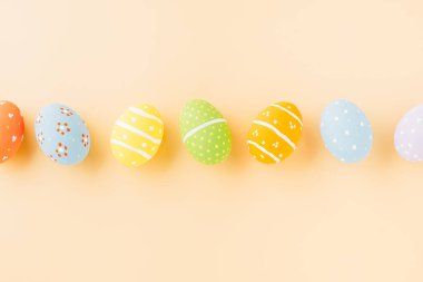 Overhead easter eggs isolated on pastel background with copy space, Funny decoration, Happy Easter Day greeting card, Creative composition banner web design holiday background, flat lay top view