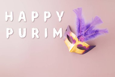 Venetian mask, Carnival mask for Mardi Gras celebration isolated on purple background banner design with copy space, jewish holiday, Purim in Hebrew holiday carnival ball, Happy Purim carnival concept