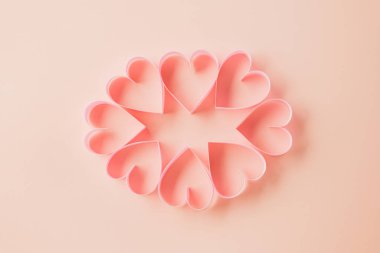 Top view flat lay pink ribbon heart shaped decorative symbol on pastel pink background, love romance concept, banner design with copy space, Mother, Woman day, Happy Valentines Day