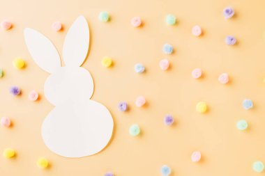 Easter Day Concept. Above overhead handmade white paper rabbit cutting isolated on pastel background with copy space for your text, Happy Easter Bunny holiday, Banner design for web