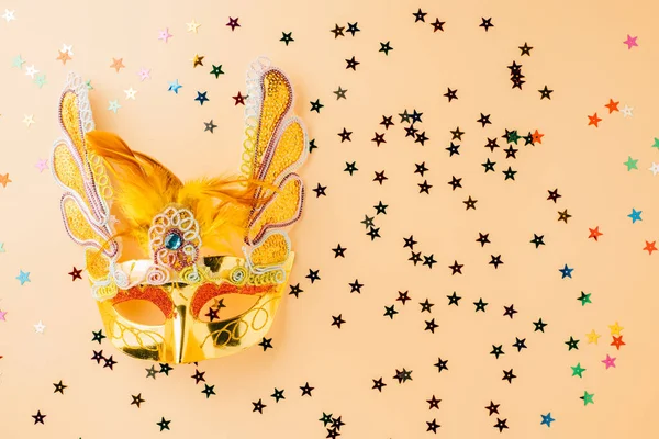 Happy Purim carnival decoration. Jewish Purim and Mardi Gras in Hebrew, celebration holiday background banner design, Golden venetian ball mask, carnival mask isolated on pastel background