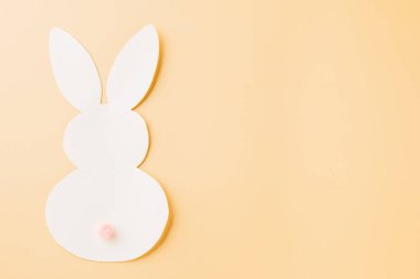 Easter Day Concept. Above overhead handmade white paper rabbit cutting isolated on pastel background with copy space for your text, Happy Easter Bunny holiday, Banner design for web