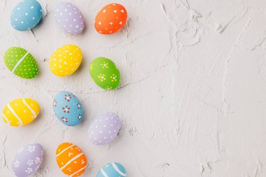 Easter Day Concept. Top view holiday banner background web design white colorful easter eggs painted on white cement background with empty copy space, celebration greeting card, overhead, template