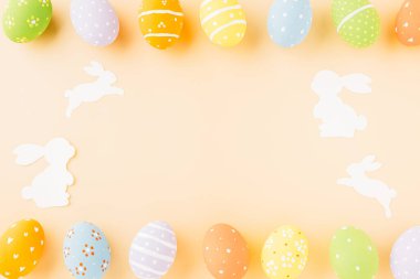 Easter eggs bunny and rabbit white paper cutting isolated on pastel background. Funny decoration, Happy Easter Day, Festive composition banner design holiday background