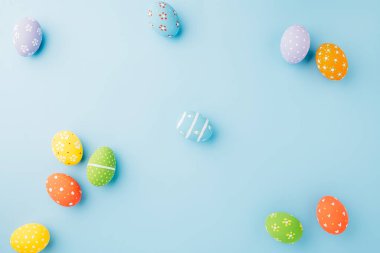 Colorful easter eggs isolated on blue background with copy space, Funny decoration, Creative composition banner web design holiday background, Happy Easter Day greeting card, flat lay top view