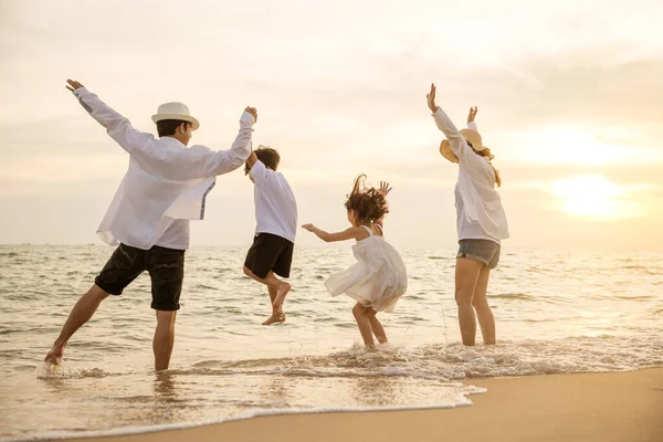 在日落时分 快乐的亚洲家庭在海滩上欢欢喜喜地共舞 手牵着手在海滩上过着健康的生活 背靠背的人们享受着旅游和度假的理念 — 图库照片
