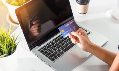 Online shopping. Woman hands holding credit card and using laptop with product purchase at home, female register via credit cards on computer to make electronic payment security online