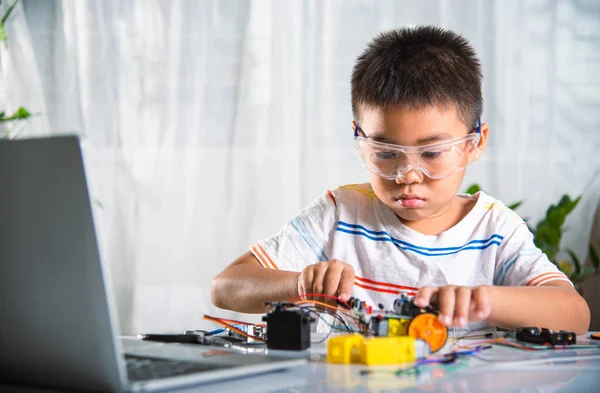 Premium Photo  Asian little boy programming code to robot machine