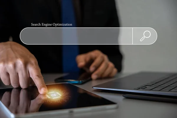 Digital marketing and SEO concept with mans hands using tablet computer. Searching for information and optimizing website for search engine results. Technology background