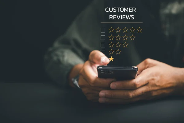 Unhappy client concept. Giving a 1-star satisfaction rating on social media using a smartphone. Negative feedback impacting business reputation and customer experience.