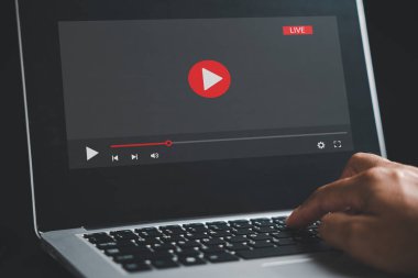 In the realm of online learning, a man dedicates himself to his laptop screen, seamlessly transitioning between video playback, educational webinars, and the digital landscape of e-learning.