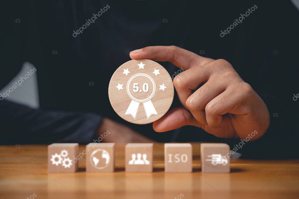 An ISO banner in the background underscores the significance of quality control and assurance. A hand places wooden cubes with ISO icons, symbolizing the standards and certification concept
