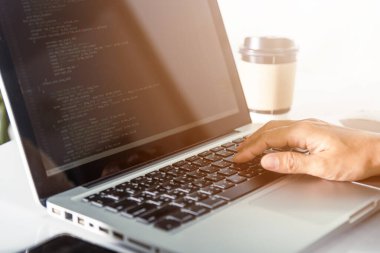 Programmer woman writing program HTML code sitting at workplace in office, IT software developer hands typing data coding programming with laptop computer, IT start up concept, Web application design