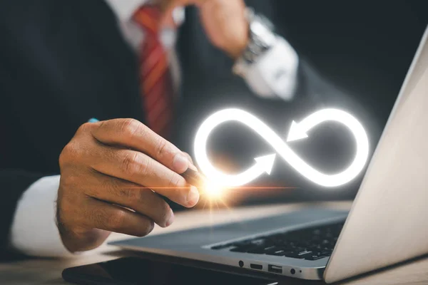 Businessman highlights infinity symbol, indicating unlimited connection in data technology. Cyber space, future unlimited. Infinite power, energy, internet information. technology infinity data