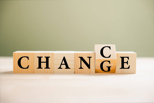 CHANCE emerges from CHANGE wooden cube flips. Personal growth and career transformation concept. Hand rotates block on wood background, innovation and success. Your future success is in motion.