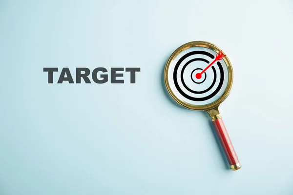 Magnifier Glass Focuses Target Board Illustrating Importance Hitting Business Objectives — Stock Photo, Image