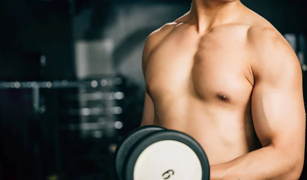 Man Lifting Weights Dark Gym Sweat Glistening His Skin Works — Stock Photo, Image